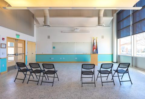 Group of chairs facing the whiteboard at the front of the room.