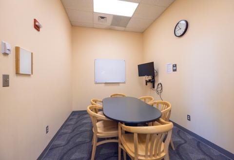 Medium oval table with chairs, TV and Blu-ray player