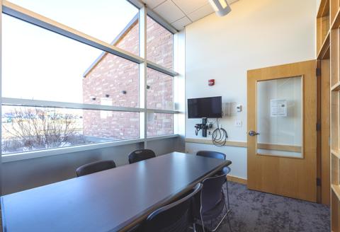 Rectangular table with chairs, TV and Blu-ray player