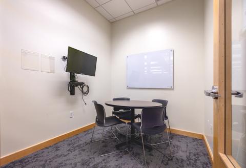 Small table and chairs, glass whiteboard, TV and Blu-ray player