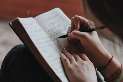 A person writing in a journal.