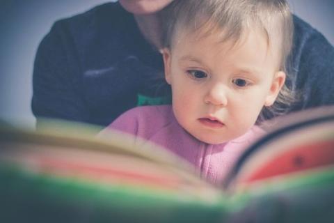 Baby with parent reading book