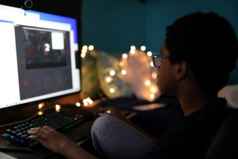 teen playing games at computer