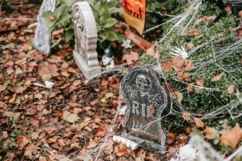 Graveyard Halloween decorations with fake spider webs.