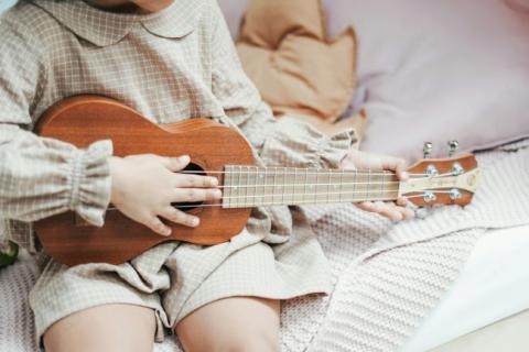 Child playing ukulele.