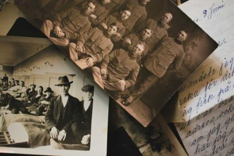 Old family papers and photos laid out on a table.