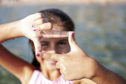 little girl with frame hands