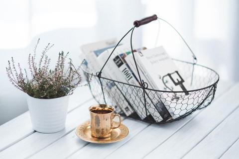 Basket of books with plant and mug