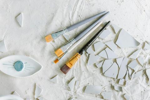 Paintbrushes and broken ceramics. 