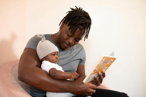 Man reading to his baby
