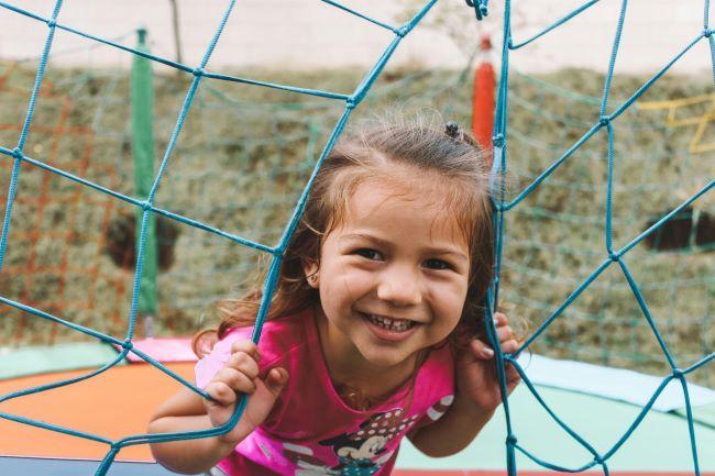 Young girl in pink shirt on playground