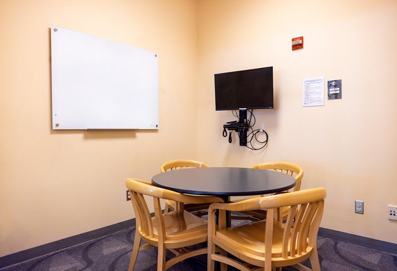 Small round table with chairs, TV and Blu-ray player