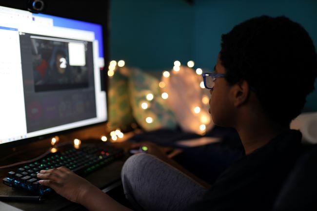 teen playing games at computer