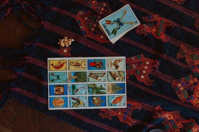 Lotería playing cards on red velvet background.