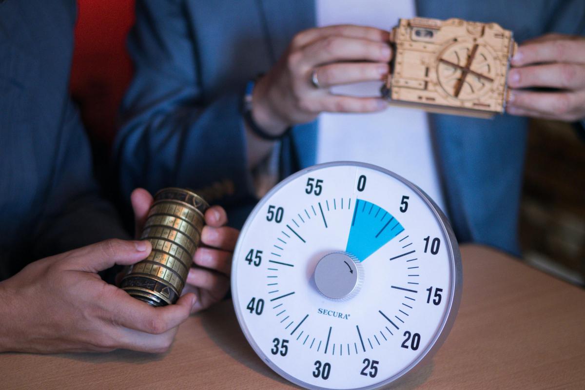 Two people are working together to solve puzzles before the timer goes off. 