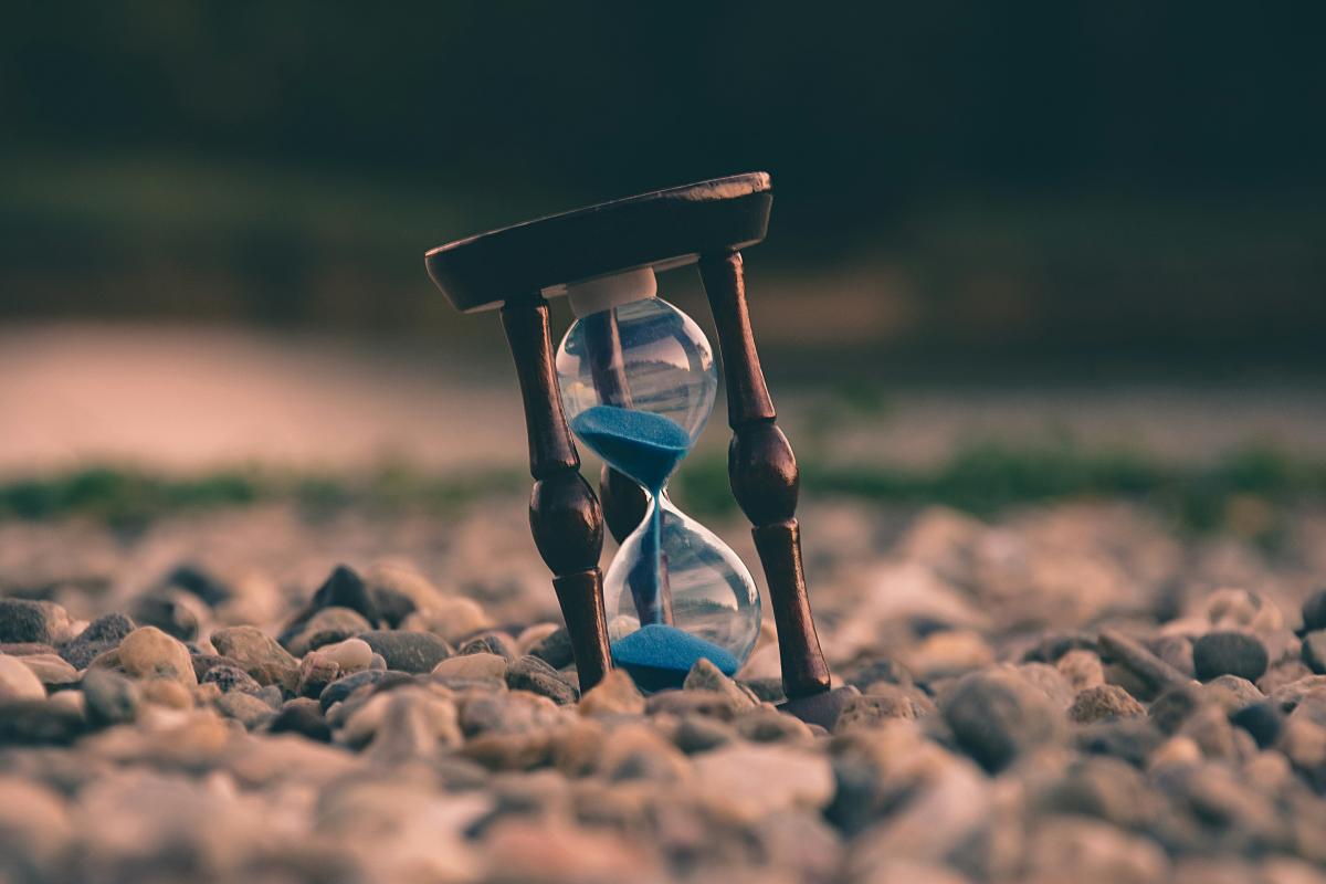 Sand timer sitting in rocks